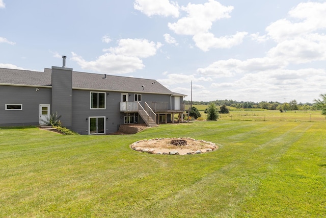 view of yard with an outdoor fire pit and a wooden deck