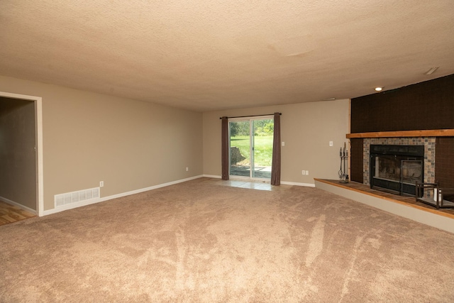 unfurnished living room with a textured ceiling and carpet floors