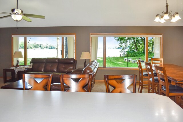 dining room featuring ceiling fan with notable chandelier