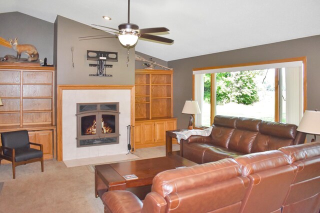 carpeted living room featuring ceiling fan and lofted ceiling