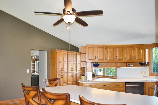 kitchen featuring ceiling fan, kitchen peninsula, lofted ceiling, and dishwasher