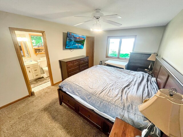 tiled bedroom featuring ceiling fan and ensuite bathroom