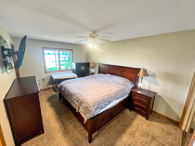 bedroom with ceiling fan and light colored carpet