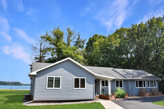 single story home featuring a front yard and a water view