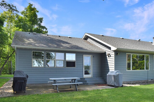 back of property featuring a lawn