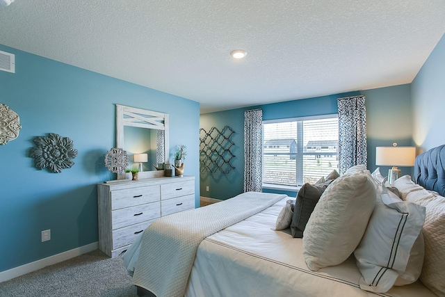 carpeted bedroom featuring a textured ceiling