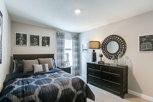 carpeted bedroom featuring a textured ceiling