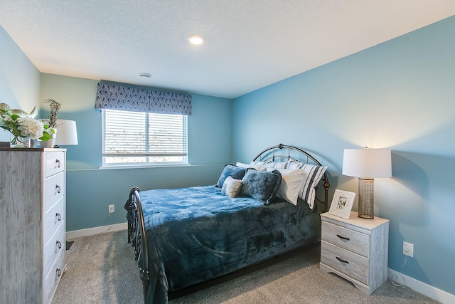 bedroom featuring carpet floors and a textured ceiling