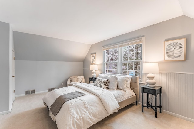 carpeted bedroom with lofted ceiling