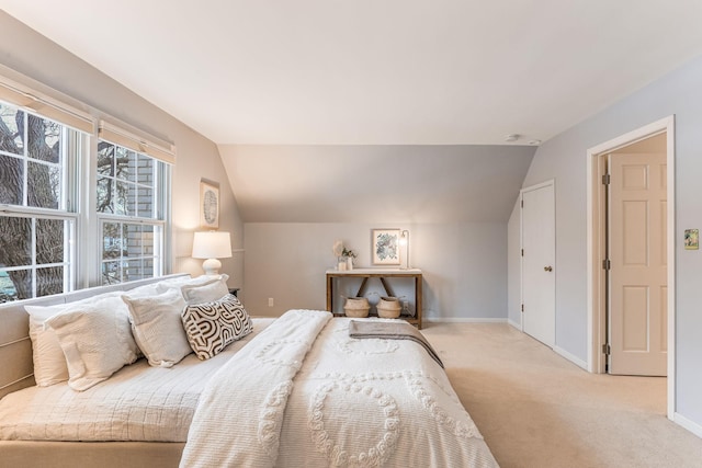 carpeted bedroom featuring lofted ceiling