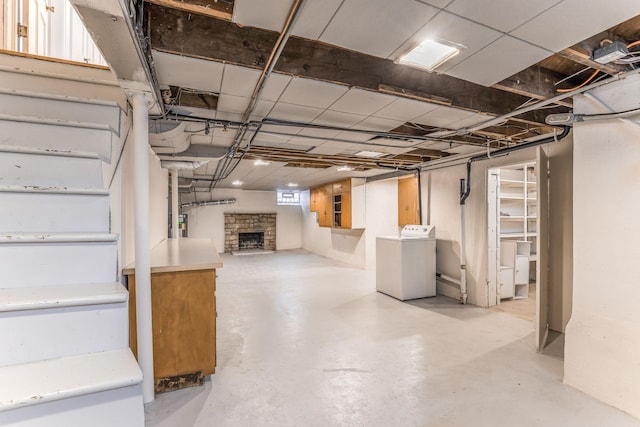 basement featuring washer / dryer and a fireplace