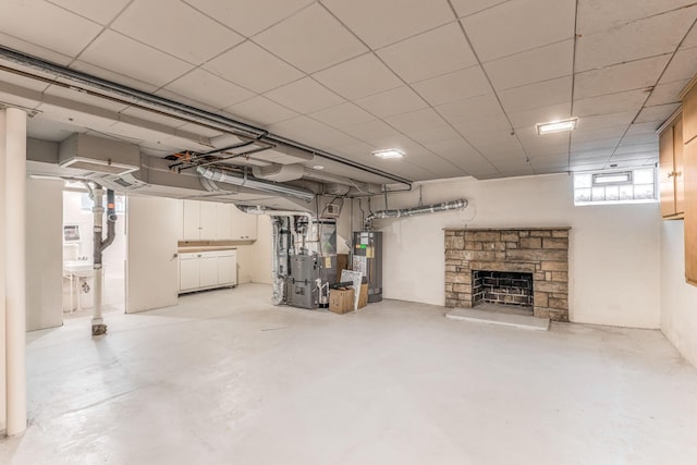 basement featuring a fireplace, heating unit, and gas water heater