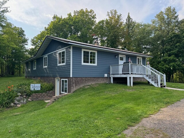 single story home with a deck, stairway, and a front lawn