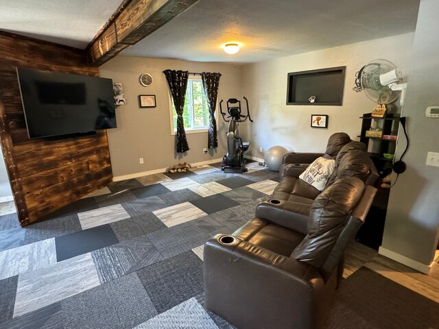 living room with a textured ceiling and baseboards