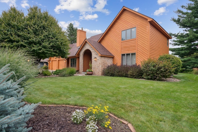 view of front facade featuring a garage, brick siding, roof with shingles, a front lawn, and a chimney