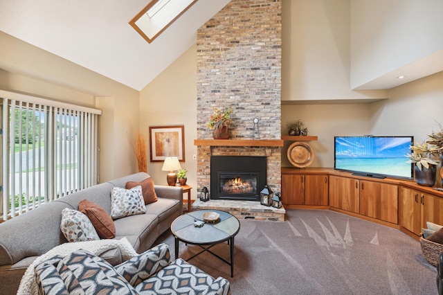 living area featuring a skylight, a brick fireplace, high vaulted ceiling, and light colored carpet