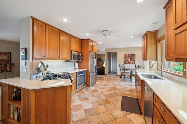 kitchen featuring a sink, brown cabinets, stainless steel appliances, and light countertops