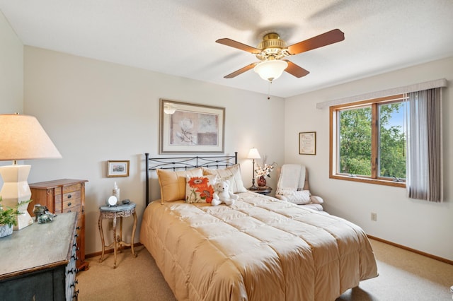 bedroom featuring light carpet, ceiling fan, and baseboards