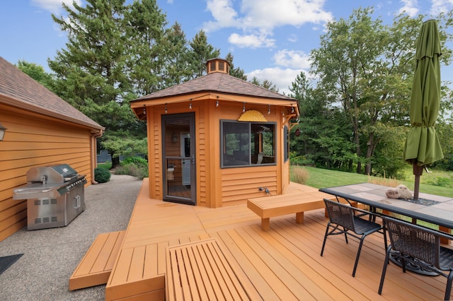 wooden deck featuring outdoor dining area and grilling area