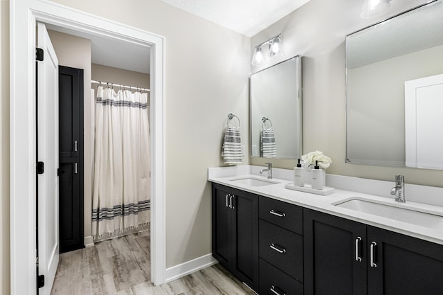 bathroom featuring vanity and hardwood / wood-style floors