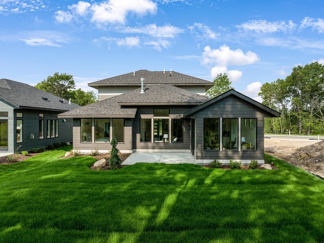 rear view of property with a yard