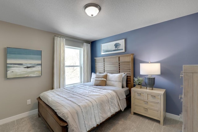 bedroom with light carpet and a textured ceiling