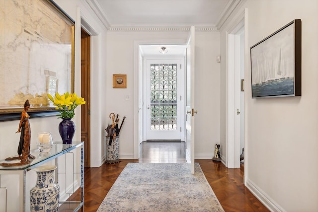 foyer featuring dark parquet flooring and crown molding