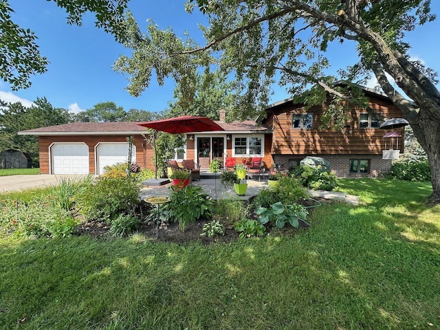 view of front of home with a front yard and a garage