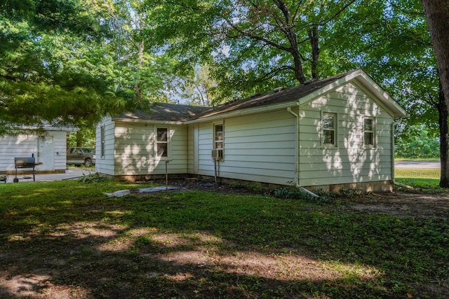 back of property featuring a yard