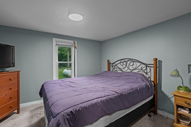 bedroom featuring light carpet and a textured ceiling