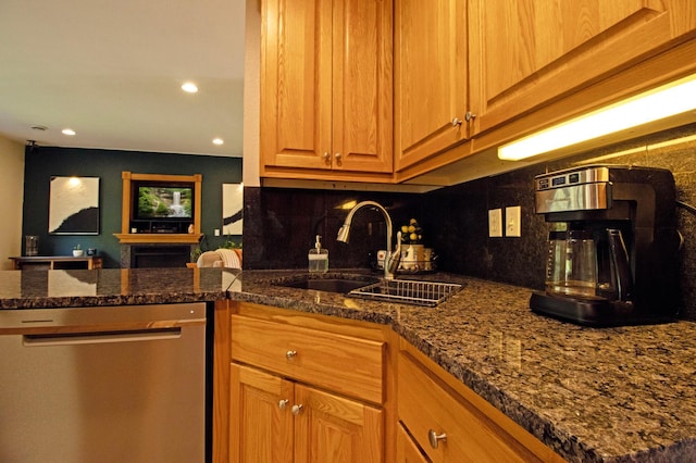 kitchen with stainless steel dishwasher, a sink, backsplash, and recessed lighting