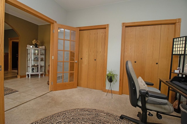 office area featuring visible vents, arched walkways, and carpet