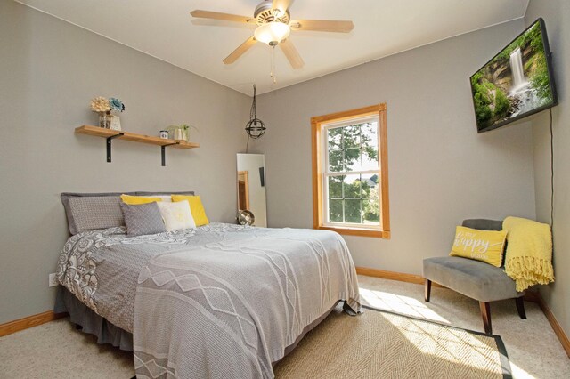 bedroom featuring baseboards and light carpet