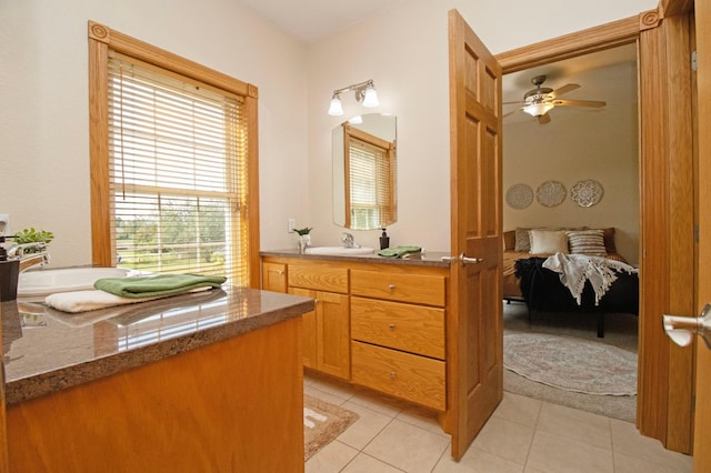 ensuite bathroom featuring vanity, ensuite bath, tile patterned floors, and ceiling fan