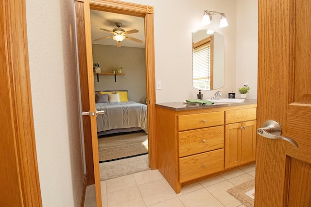 ensuite bathroom with vanity, tile patterned flooring, ensuite bathroom, and a ceiling fan