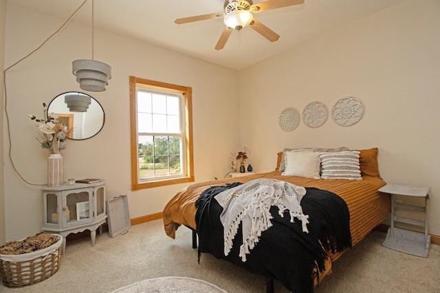 bedroom featuring baseboards, ceiling fan, and carpet