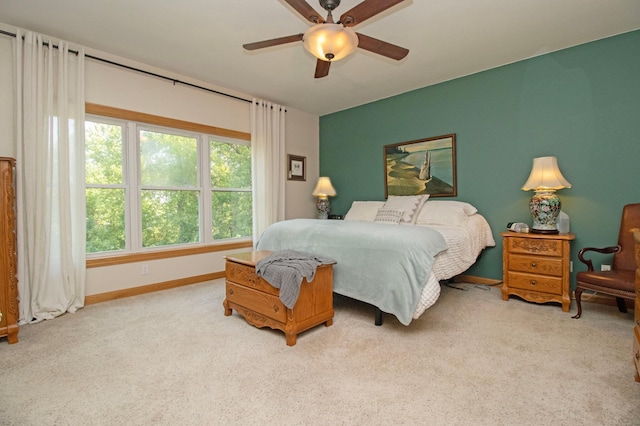 bedroom with baseboards, light carpet, and ceiling fan