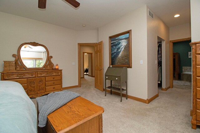 bedroom with light colored carpet, a ceiling fan, baseboards, and visible vents