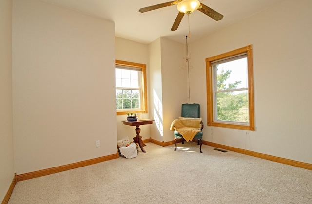 sitting room featuring baseboards, carpet, ceiling fan, and visible vents