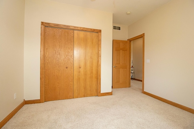 unfurnished bedroom with baseboards, carpet flooring, and visible vents