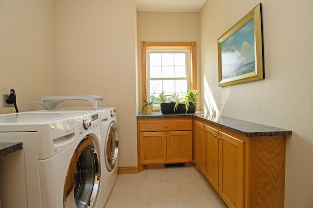 laundry area with light tile patterned floors, cabinet space, and independent washer and dryer