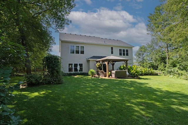 back of house with a gazebo and a lawn