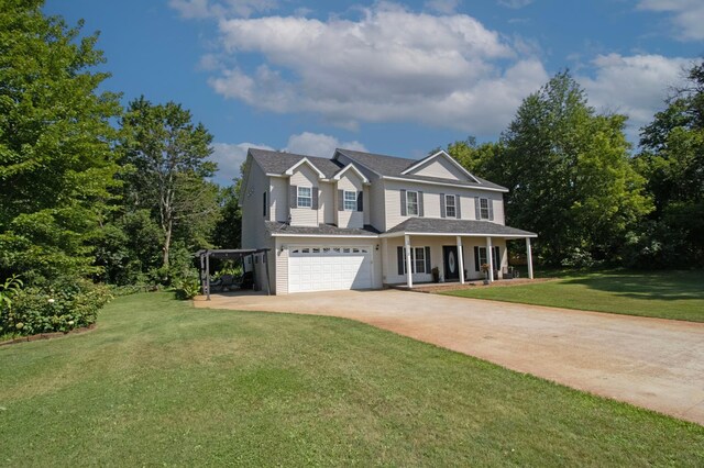 traditional-style home featuring an attached garage, concrete driveway, a porch, and a front lawn