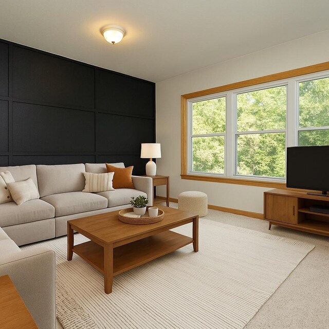 living area featuring baseboards, plenty of natural light, and light carpet