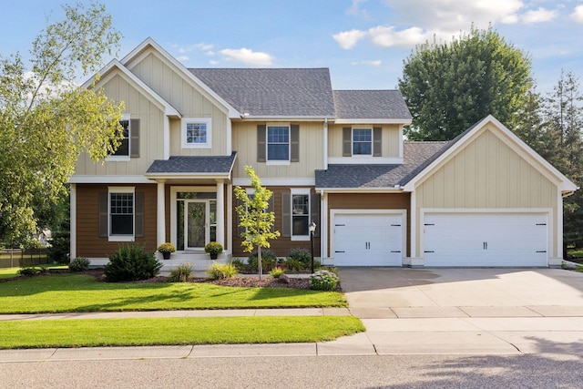 craftsman-style home featuring a garage, a shingled roof, concrete driveway, a front lawn, and board and batten siding