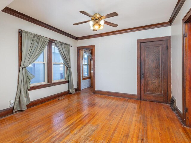 unfurnished room featuring ceiling fan, ornamental molding, and light hardwood / wood-style flooring