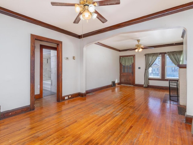 spare room with ceiling fan, wood-type flooring, and crown molding