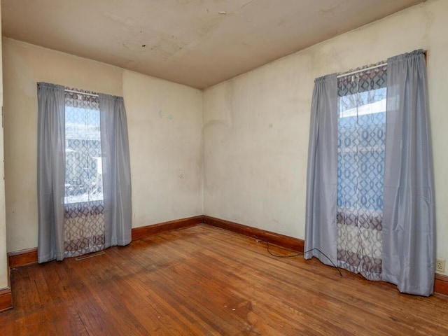 empty room with hardwood / wood-style floors