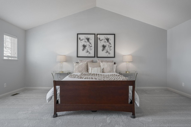 bedroom featuring carpet, vaulted ceiling, and baseboards