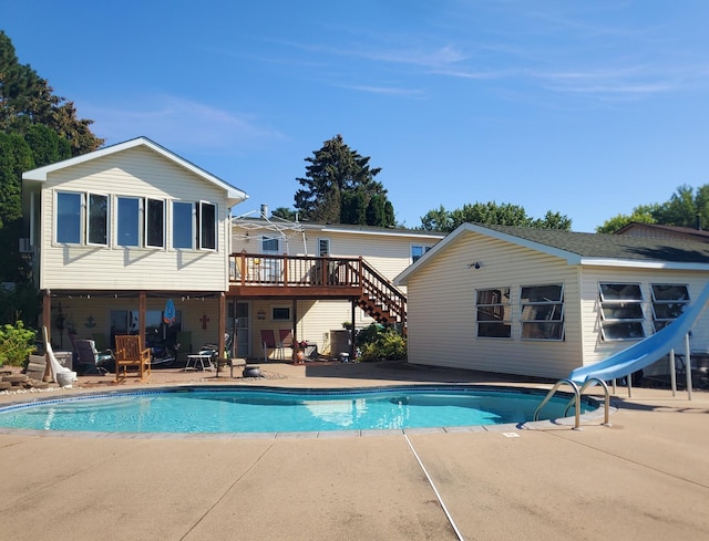 10873 69th Ave N, Maple Grove, MN 55369 - swimming pool with a water slide, a patio, a wooden deck, and stairway